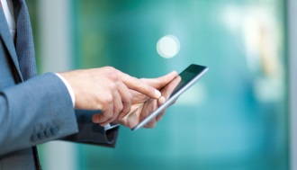 Closeup of a man using a digital tablet